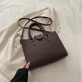 Dark brown pebble leather tote bag with dual handles and detachable shoulder strap - Brown