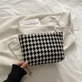 Classic black and white checkered woven makeup bag with thick texture in flat lay - Black
