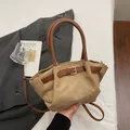 Chic khaki suede crossbody bag with brown leather handles and gold metal buckle detail - Khaki
