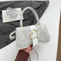 Cream square shoulder bag with letter print flap and golden D-buckle closure - White