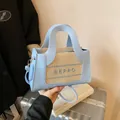 Light blue leather and straw handbag with BEPRO logo print and detachable crossbody strap - Blue