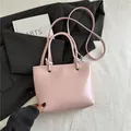Minimalist light pink PU leather tote bag with silver grommets and knotted shoulder strap - Pink