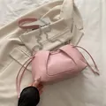 Pink pleated faux leather shoulder bag with silver chain strap and drawstring detail - Pink