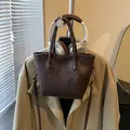 Deep brown faux leather tote bag with vintage texture and golden metal hardware details - Coffee without Pendant