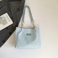 Light blue tote bag with silver star patterns and golden chain strap detail - Blue Without Charm