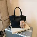 Sleek black leather commuter tote with puppy charm and detachable shoulder strap - Black With Pendant