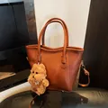 Brown vintage style faux leather tote bag with a cute plush dog charm accessory - Brown with Pendant