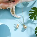 Detail of champagne gold pearl jewelry set on a sea shell with tropical leaves - Champagne Gold (HWNX8841-7)