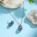 Detail of gold-plated necklace and grey shell pearl earrings on white coral stone - Dark Gray (HWNX8841-12)