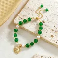 Detail of beaded bracelet with green jade beads, pearls, and a gold shell pendant charm - Bowknot Style (HWB0463)