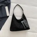 Black matte suede hobo tote bag with matching coin purse on a minimalist white backdrop - Black