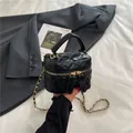 Classic black quilted crossbody bag with gold chain strap and elegant top handle - Black