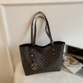 Brown monogram tote bag with repeating M pattern and golden metallic logo pendant - Coffee