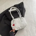Weiße Handtasche aus Litschi-Leder mit rotem Herzanhänger, perfekt für den täglichen Weg - Weiß