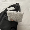 White bridal clutch bag with 3D floral rosettes and elegant gold metal zipper detail - White