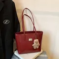 Deep red glossy patent leather tote bag with gold hardware and plush bear charm - With Pendant / Red