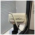 Detailed view of white faux leather baguette bag with elegant golden horsebit buckle - White