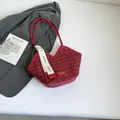 Red tweed tote bag with V-shaped opening and gold metallic accents on a sleek background - Red