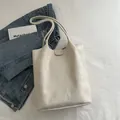 Minimalist beige matte leather tote bag with flap closure for daily commuting use - White