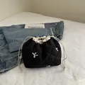 Quilted black drawstring bucket bag with white floral embroidery and cotton straps - Black