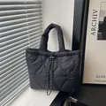 Large black quilted tote bag with heart patterns and drawstring closure for women - Black