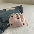 Pink quilted drawstring cosmetic bag with black embroidered bows and floral patterns - Pink