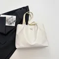Chic white faux leather tote bag with elegant bow detail and spacious interior - White