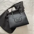 Large black tote bag with M monogram print and embossed logo for stylish commuting - Black