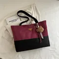 Large tote bag in burgundy and black contrast suede with a golden metal logo - With Pendant / Red