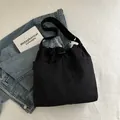 Large black nylon drawstring tote bag with adjustable shoulder strap and side pocket - Black (Without Charm)