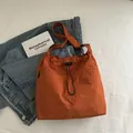 Orange-red nylon drawstring tote bag with textured fabric and wide shoulder strap - Orange (Without Pendant)