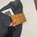 Brown quilted puffer makeup bag in mustard tan with grid stitching handheld style - Brown