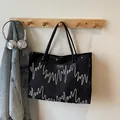 Black large-capacity tote bag with pleated texture and wavy white stitch embroidery - Black