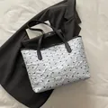 White tote bag with black bow patterns and textured bubble fabric finish - Blue