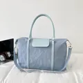 Large light blue travel bag with pleated texture and adjustable shoulder strap - Blue