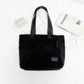 Classic black corduroy tote bag with durable shoulder straps and minimalist retro design - Black