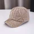 Detailed close-up of khaki knit baseball cap featuring glittering gold rhinestone patterns - Adult Size (Adjustable) / Khaki