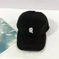 Close-up of black fuzzy lamb wool baseball cap featuring white embroidered R letter - Adult, Adjustable / Black