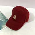 Detailed close-up of dark red sherpa baseball cap featuring a retro letter R embroidery - Adult, Adjustable / Burgundy