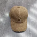 Detail of brown teddy fleece baseball cap featuring a white R letter embroidery - Adult, Adjustable / Khaki