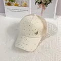 Detail of mesh baseball cap with gold sequins and a metallic butterfly accessory - Adult (55-60cm Adjustable) / Beige