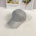 Close-up of gray baseball cap featuring floral lace overlay with shimmering sequins and MC logo - 56-60cm / Gray