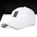 White golf baseball cap for men with brown leather patch and wide sun protection brim - White