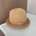 Detail of camel plush bucket hat featuring a gold metal M logo and ribbed ribbon band - M (56-58cm) / Khaki (With M Logo)