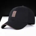 Men's black cotton golf baseball cap with brown leather patch and curved brim detail - Black