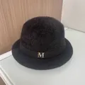Detail of black fuzzy bucket hat featuring a gold M letter buckle with rhinestones - M (56-58cm) / Black (With M Logo)