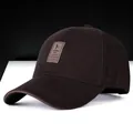 Deep brown cotton baseball cap featuring a leather patch with a golf swing silhouette - Dark Brown