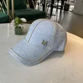 Light blue tweed baseball cap with rhinestone M logo and gold chain trim detail - Blue