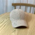 Dettaglio ravvicinato del cappellino invernale in tweed con scritta NYC e strass luminosi - Taglia Adulto (Regolabile) / Cachi