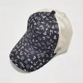 Close-up of printed tie-dye trucker hat featuring graffiti patterns and mesh back detail - Black and White Graffiti Style